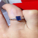 1 carat blue rectangle moissanite ring with a platinum-plated finish and brilliant sparkling gemstone.