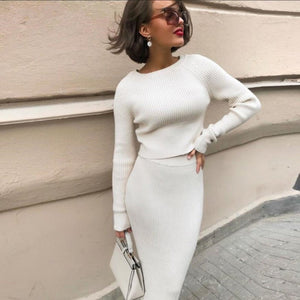 Woman wearing a light blue knit sweater and skirt two-piece set