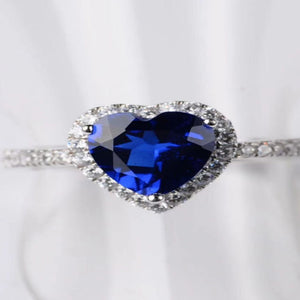 2 carat heart-shaped moissanite ring with sparkling side stones and brilliant shine.