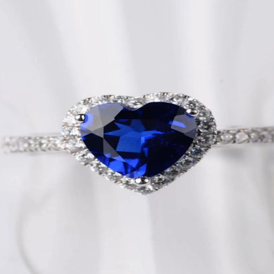 2 carat heart-shaped moissanite ring with sparkling side stones and brilliant shine.