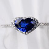 2 carat heart-shaped moissanite ring with sparkling side stones and brilliant shine.