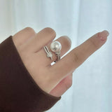 Elegant pearl zircon bypass ring with a synthetic pearl and sparkling zircon accents in a modern open design.