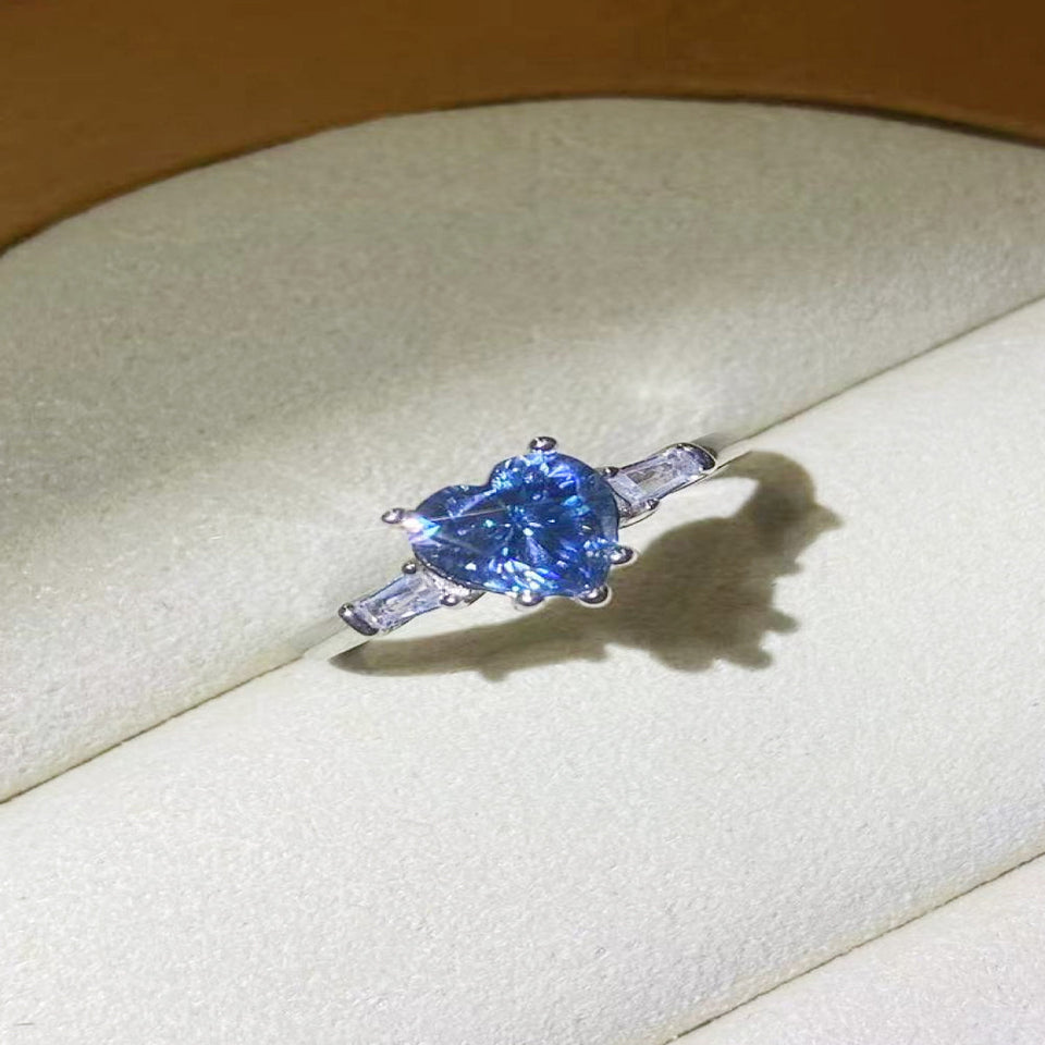 1 carat blue heart-shaped moissanite ring with a platinum-plated finish and brilliant sparkling gemstone.