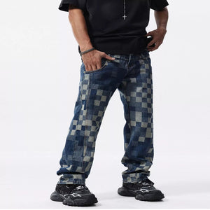 Men's checkerboard pattern relaxed fit denim jeans with a modern casual style.