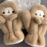 Woman wearing a cute plush bear winter hat with matching warm gloves in cream color.