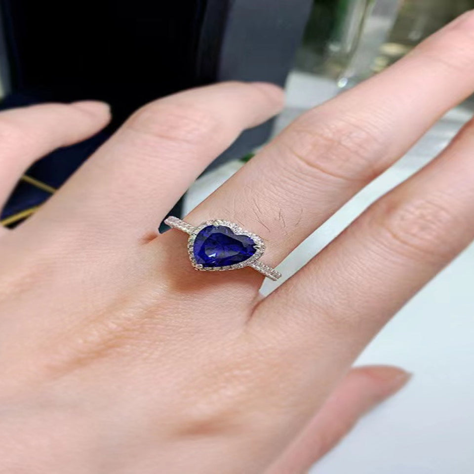 2 carat heart-shaped moissanite ring with sparkling side stones and brilliant shine.