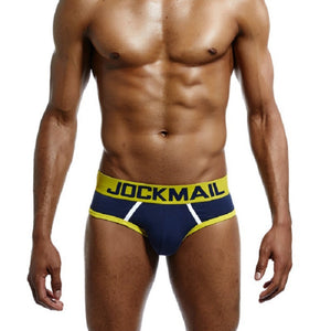 Man wearing red and black men's cotton low-rise briefs with a soft elastic waistband and supportive fit.