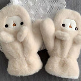 Woman wearing a cute plush bear winter hat with matching warm gloves in cream color.