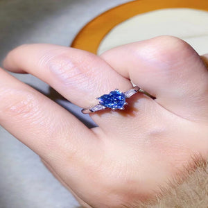 1 carat blue heart-shaped moissanite ring with a platinum-plated finish and brilliant sparkling gemstone.