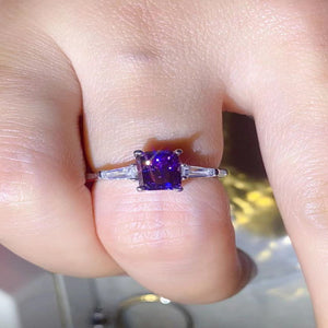 1 carat purple rectangle moissanite ring with a platinum-plated finish and brilliant sparkling gemstone.