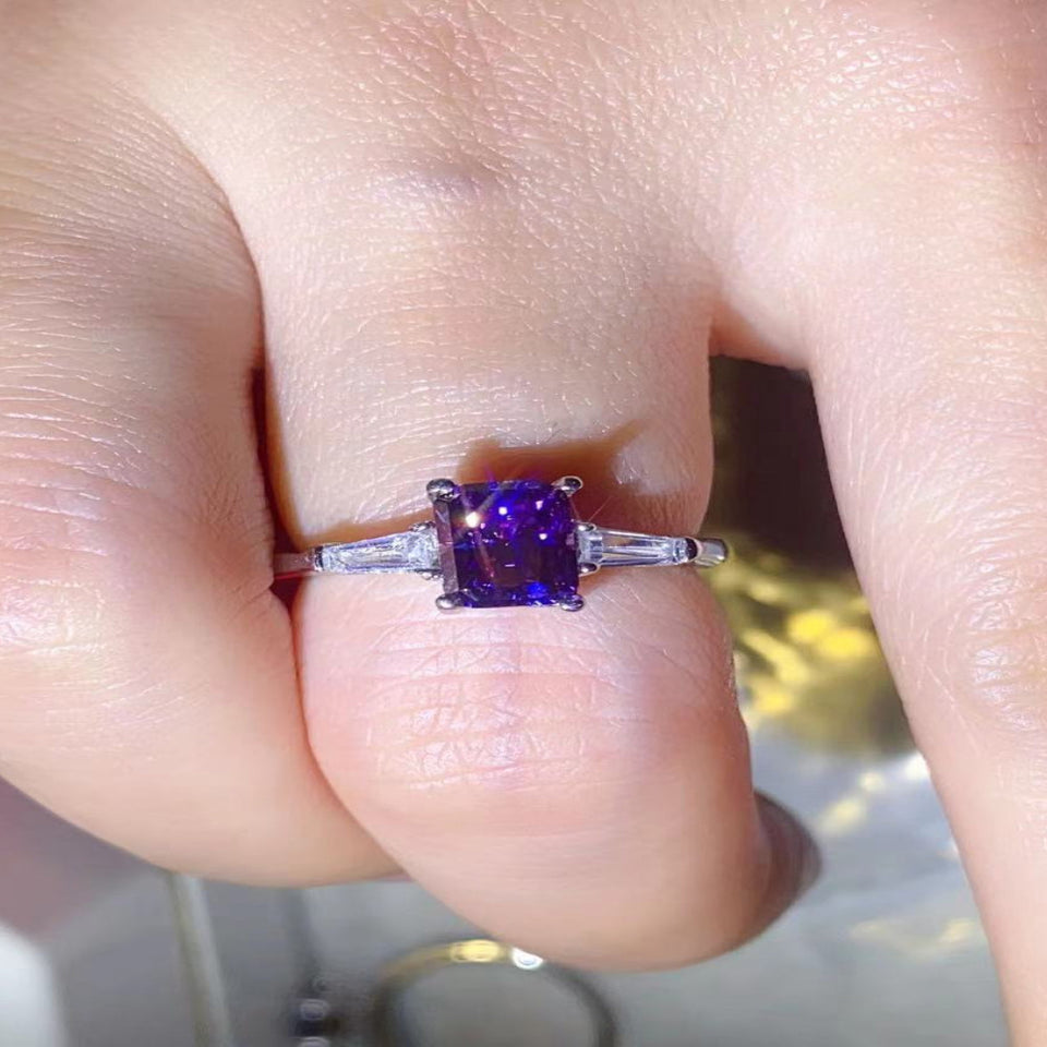 1 carat purple rectangle moissanite ring with a platinum-plated finish and brilliant sparkling gemstone.