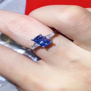 1 carat blue rectangle moissanite ring with a platinum-plated finish and brilliant sparkling gemstone.