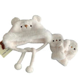 Woman wearing a cute plush bear winter hat with matching warm gloves in cream color.