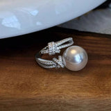 Elegant pearl zircon bypass ring with a synthetic pearl and sparkling zircon accents in a modern open design.